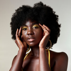 Black woman, fashion and face beauty in makeup against a mockup studio background. Portrait of a is