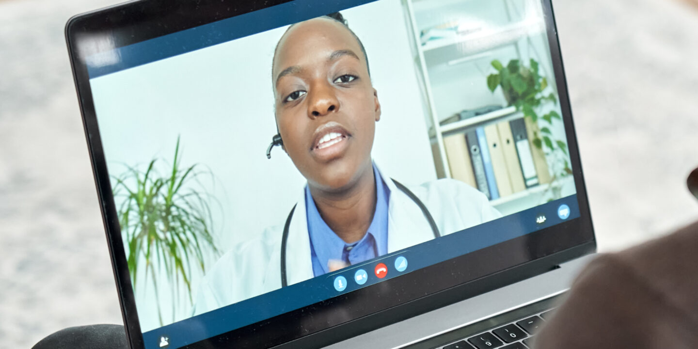 Male black patient on conference video call with female african doctor.